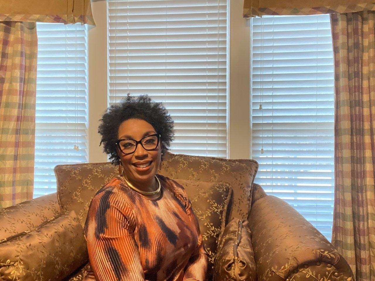 Jeanine C. Holland seated in her home, smiling warmly