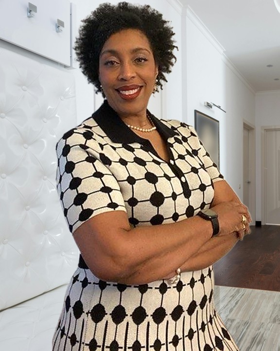 Jeanine C. Holland, Certified Master Etiquette Professional, in an elegant white foyer
